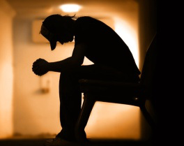 Young man with hands clasped together